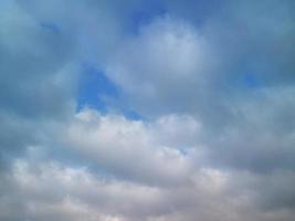 Multi-colored clouds fly over the village photo