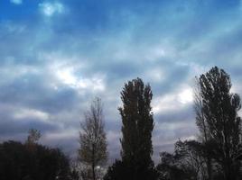 Multi-colored clouds fly over the village photo