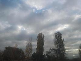 Multi-colored clouds fly over the village photo