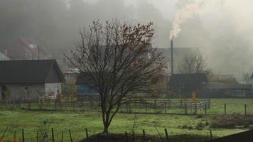 Morning landscape in the village. Little fog. White smoke from the chimney of one of the houses. video