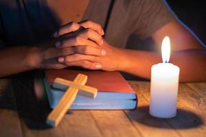 Religious Christian Child  praying over Bible indoors, Religious concepts photo