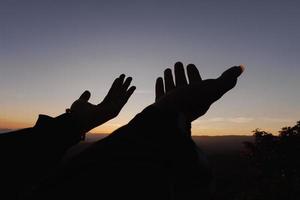 Silhouette of Human hands open palm up worship. Eucharist Therapy Bless God Helping Repent Catholic Easter Lent Mind Pray. Christian Religion concept background. fighting and victory for god. photo