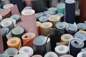 Detailed close up view on samples of cloth and fabrics in different colors found at a fabrics market photo