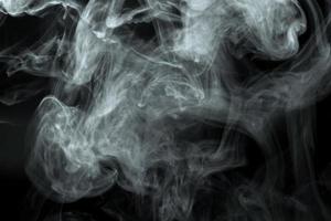 Abstract  powder or smoke isolated on black background photo