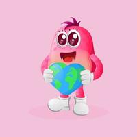 Cute pink monster holding earth with love shape vector
