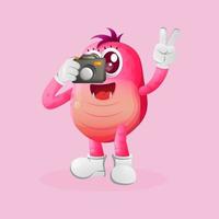 Cute pink monster taking photo with camera vector