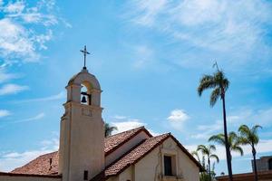 church bell tower with rpalm trees photo