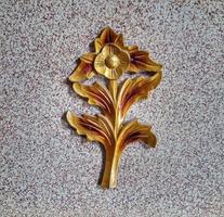 Unique gold flower carvings made of wood are good for wall decoration photo