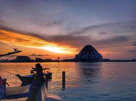 Makassar, Indonesia, June 31, 2022-a mosque in the middle of the sea looks beautiful surrounded by sunsets located on Losari beach photo
