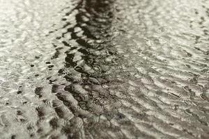 Water in spring. Waves on surface. Spring puddle. Details of nature. photo