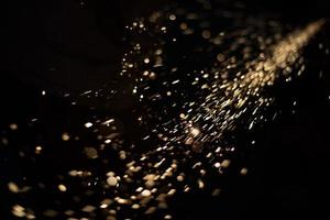 Sparks in dark. Metal grinding lights. Details of grinder's work. photo