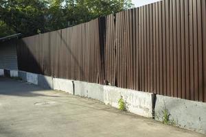 Fence around construction fence made of metal profile. Brown steel profile. photo