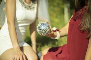 Girl holding ball. Girls on picnic. Details of outdoor recreation. photo