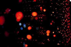 Red dots in space. Lights in dark. Red light bulbs. Lot of small lights in frame. photo