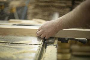 Carpenter holds board. Hand of master. photo