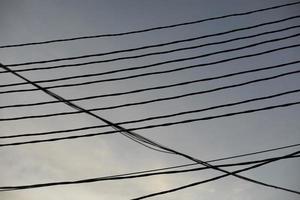 Electrical wires on pole. Many wires against sky. photo