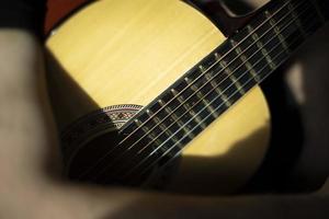 Acoustic guitar six strings. Old guitar in sunlight. photo
