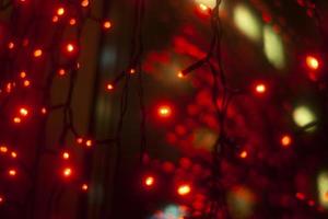 Red garlands in interior. Lights in dark. Room details. Light on window. photo