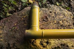 Yellow gas pipe. Pipes for communications. Steel part after painting. photo