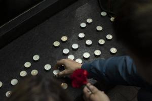 Candles on grave. Details of ceremony. Wax candles are round. photo