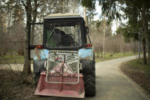 Harvesting equipment in park. Heavy technical with large wheels. photo