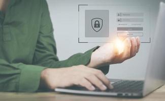 cyber security concept man's hand using a smartphone to the system through the fingerprint scanner Store data into online Cloud Data storag for security. photo