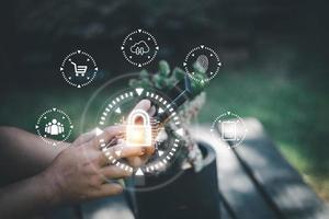 cyber security concept Man's hand using a smartphone showing a padlock icon to show that the smartphone is protected from hackers from hacking, logging in. online trading or use of social media photo