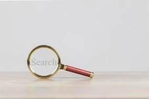 search engine optimization concept  a magnifying glass showing to search for information on social media via the Internet online photo