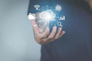 cloud computing concept man's hand holding a virtual image cloud storage which is a form of digital computer data storage That helps facilitate both small and large organizations as well photo