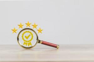 certification and quality concept  a magnifying glass showing  icon showing quality assurance certificate organization must have a certificate confidence in good service. create satisfaction f photo