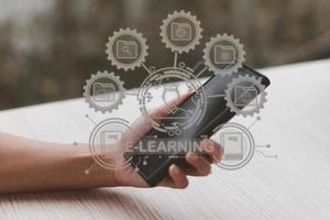 e-learning and education concept, woman's hand using a smartphone, showing icons, learning through a technological medium or online. that reduces the constraints on time and place of study photo