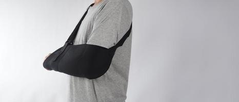 Broken arm. Arm Sling therapy support and covered around elbow first knuckle broken arm. photo