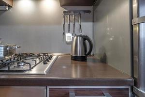 furniture and tableware on modern luxure kitchen  in studio apartments in minimalistic style with light color photo