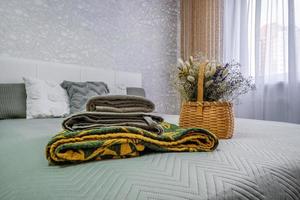 interior of the modern luxure bedroom in studio apartments in light color style with pillows and towels photo