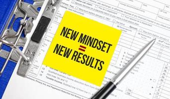 Text New Mindset - New Results on white paper with tax forms photo