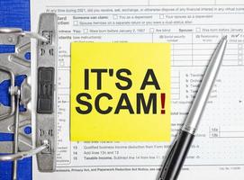 it is a scam on white paper with tax forms photo