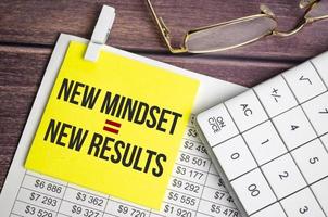 New Mindset - New Results text on yellow sticker and charts photo