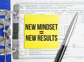 Text New Mindset - New Results on white paper with tax forms photo