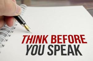 think before you think words on white paper and pen photo