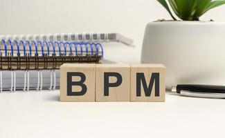 BPM Business Process Management concept, wooden word block on the grey background photo