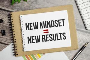 New Mindset - New Results on brown notebook and charts photo