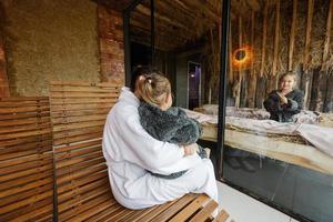 Mother with daughters in bath robe relaxing in the salt room with hay. photo