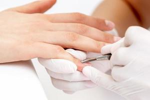 Woman receiving nail care procedure photo