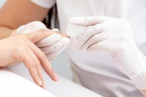 Close up of woman receiving manicure photo