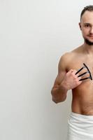 Young man shaving his chest photo