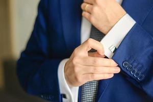 Groom or businessman fasten cufflink photo