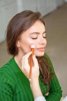 Professional make up artist applying powder photo