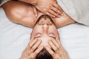 Man receiving relaxing head massage. photo