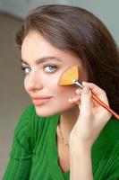 Professional make up artist applying powder photo