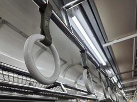 The hand handle or handgrips or handrails of commuter line passengers swaying due to the movement of the train. photo